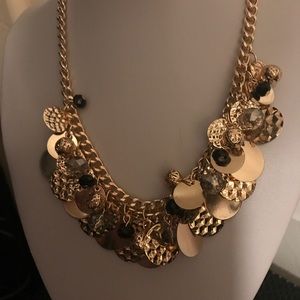 Beautiful gold necklace with a little black beads