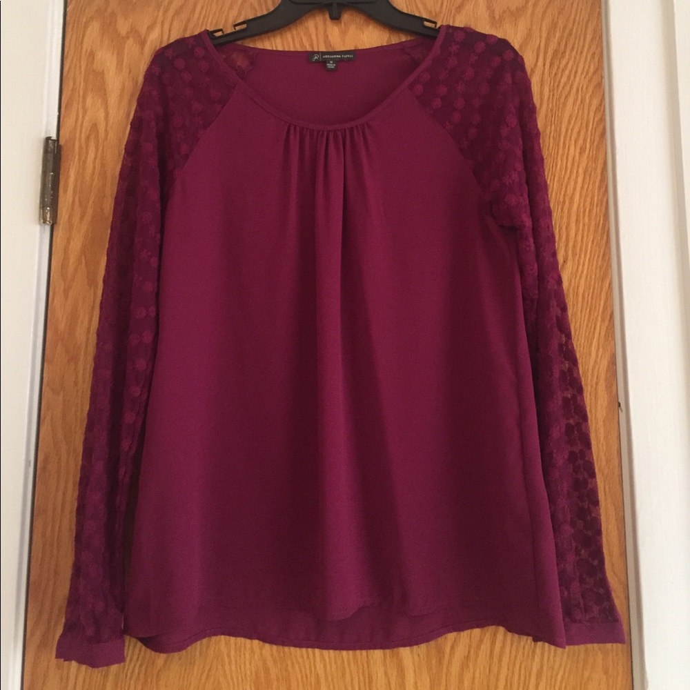 Blouse with sheer sleeves.