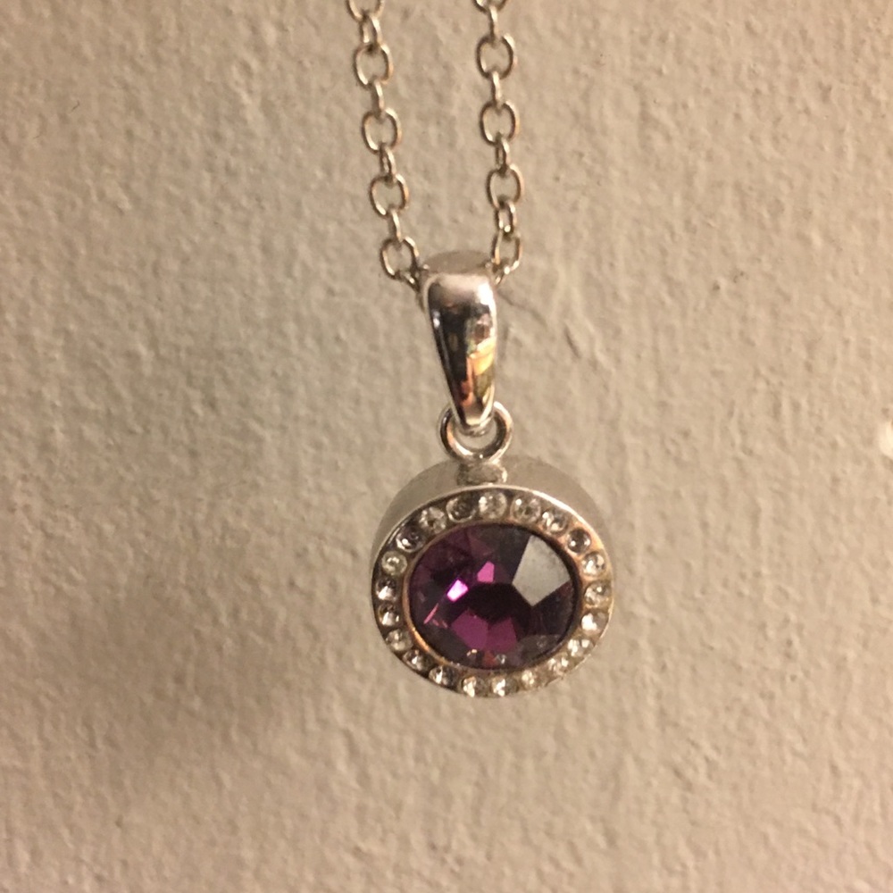 Purple gem necklace surrounded by rhinestones