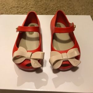 Mini Melissa Red Dress Shoes with cream bow.