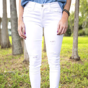 Distressed white jeans