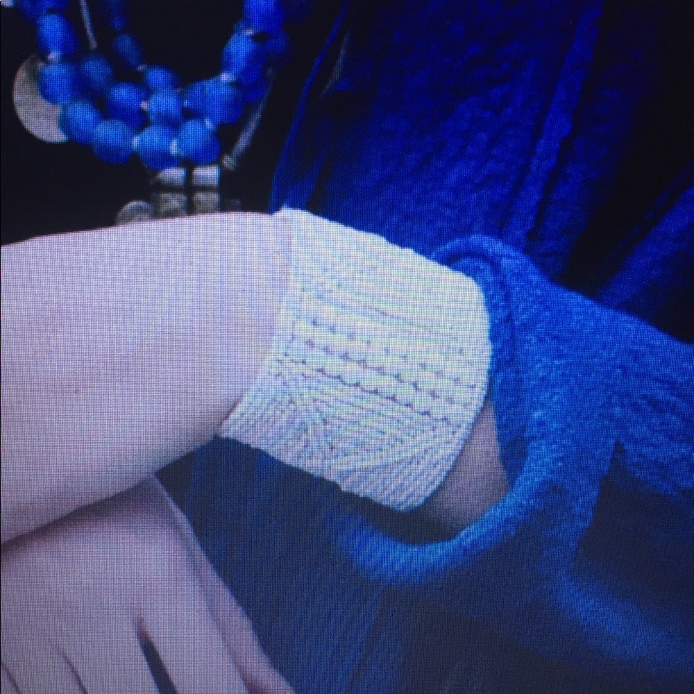 White beaded cuff on leather.