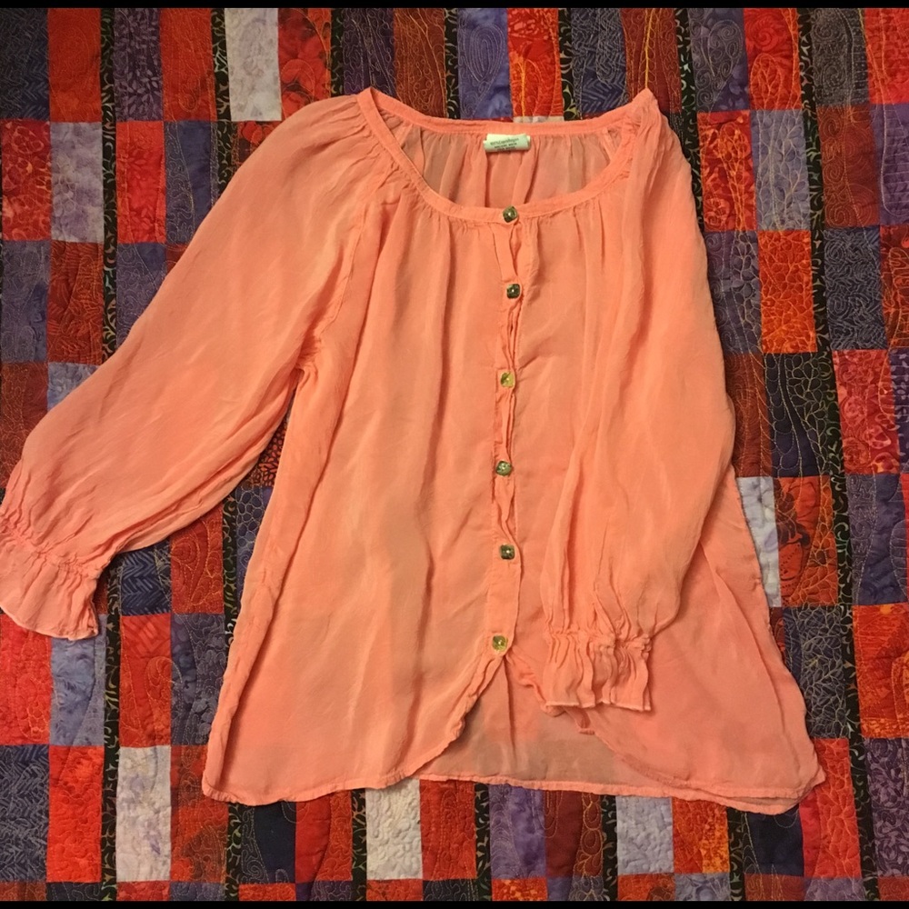 Salmon colored women’s blouse with rock buttons