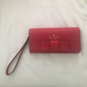Red Kate Spade saffiano leather wristlet w/ bow