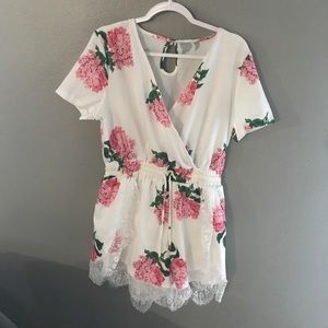 White romper with pink flower print.
