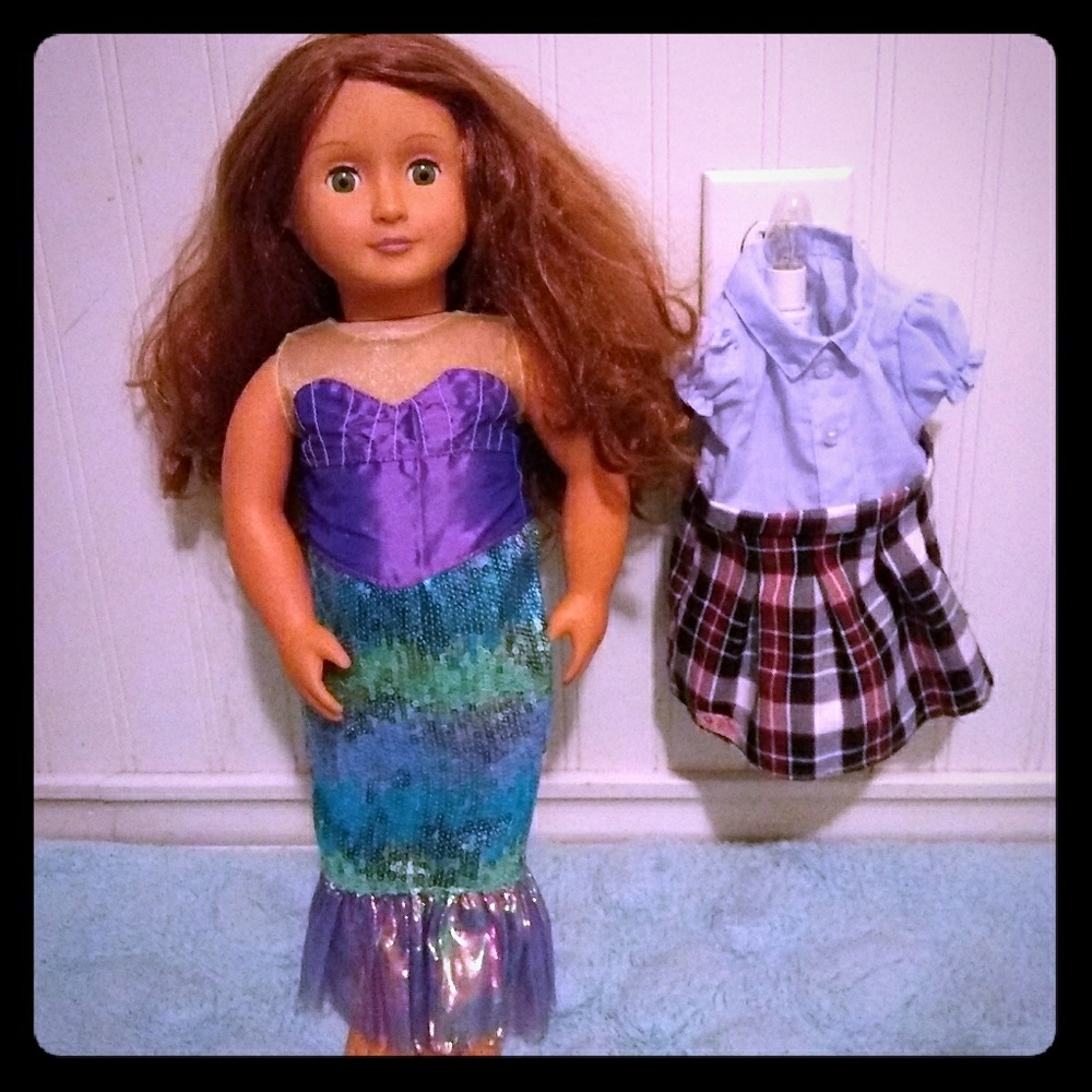 A dall with a mermaid costume and a school uniform
