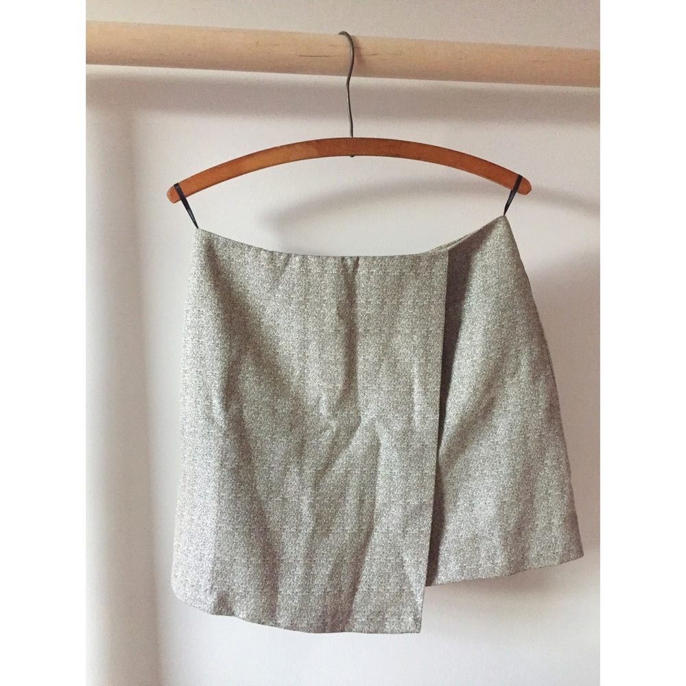 A symmetrical mini skirt subtle gold fabric