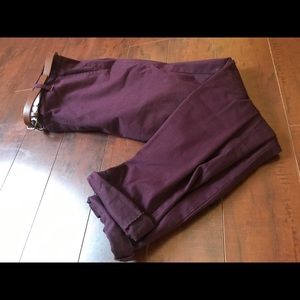 Burgundy chinos with bottoms cuffed with belt