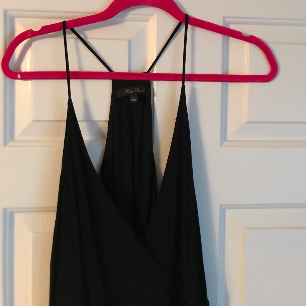Deep V neck black dress with fringe.