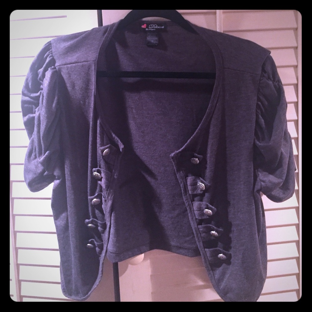 Gray short sleeve shrug with ruffle sleeves.
