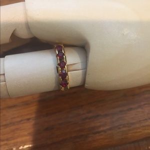 Goldtone band with 5 red channel set stones, size7