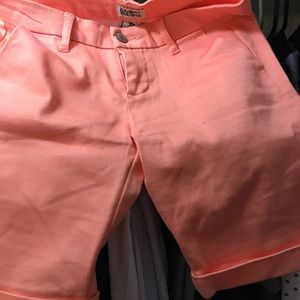 Pink Bermuda shorts.