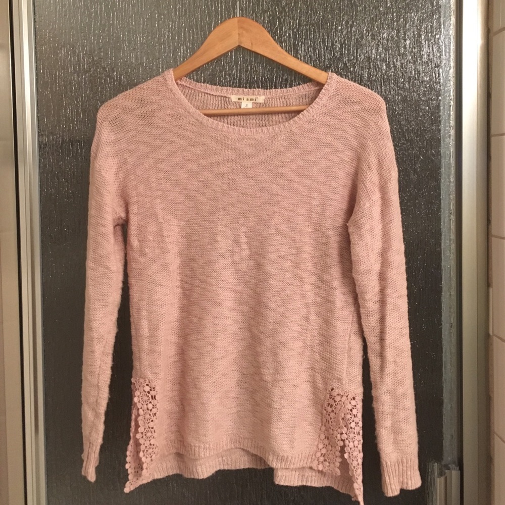 Peach colored knit sweater.