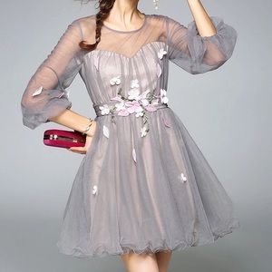 Beautiful tulle mini dress with flower accents.