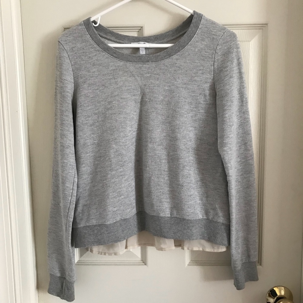 Gray Delia’s shirt with ruffles in back