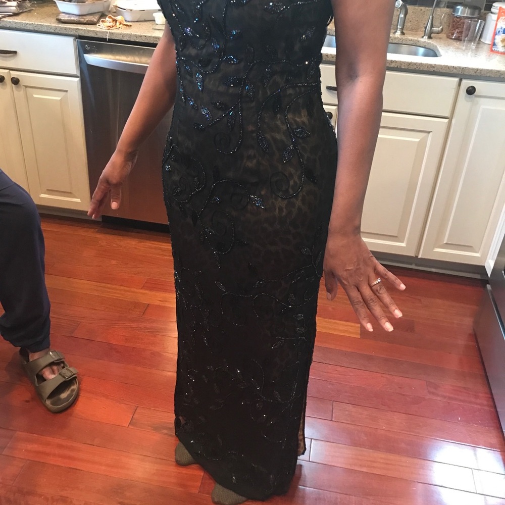 Black beaded spaghetti strap gown.