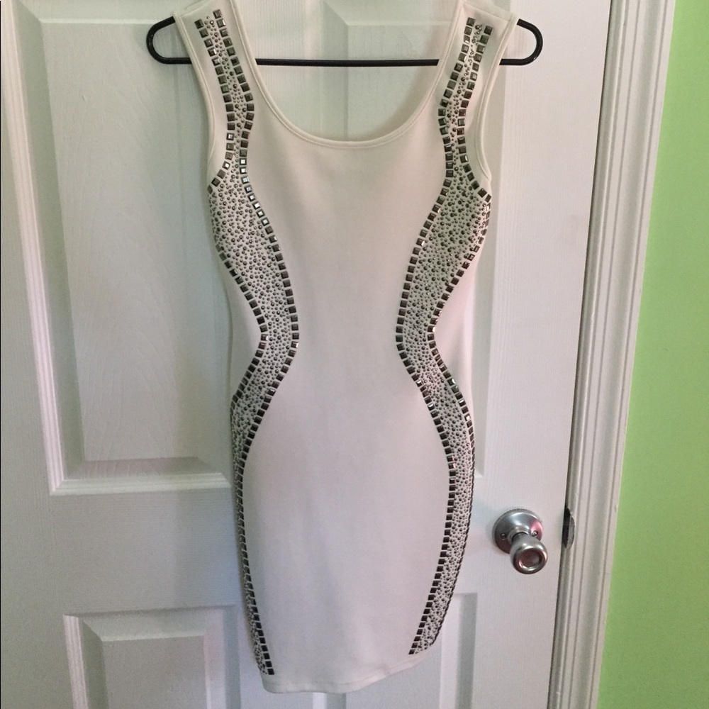 Form fitting white dress with studs.