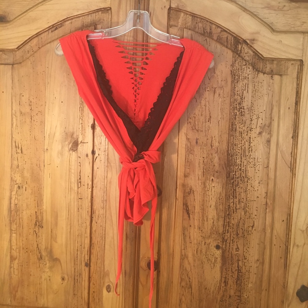 Orange, stretchy knit, wrap around top.
