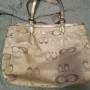 Coach handbag, silver in color with pink lining