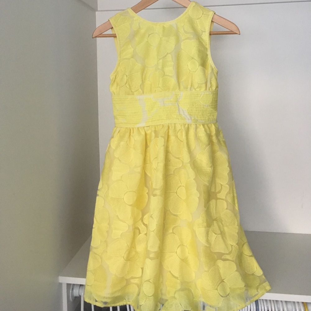 Yellow sleeveless dress with floral overlay