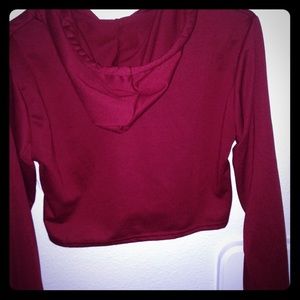 Deep red cropped hoodie.