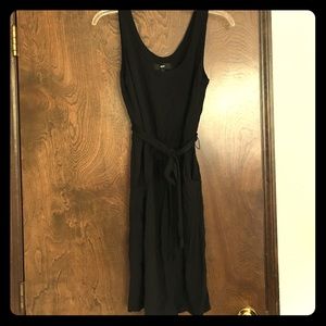 Above-knee black sleeveless dress