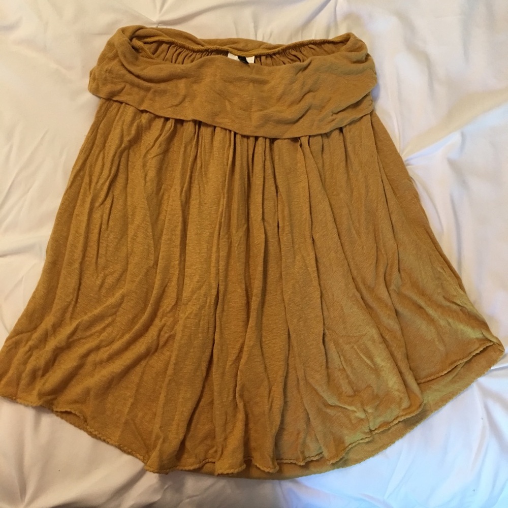 Mustard colored high low skirt.