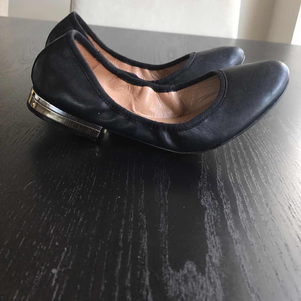 Black flats w/ gold and silver heel detailing.