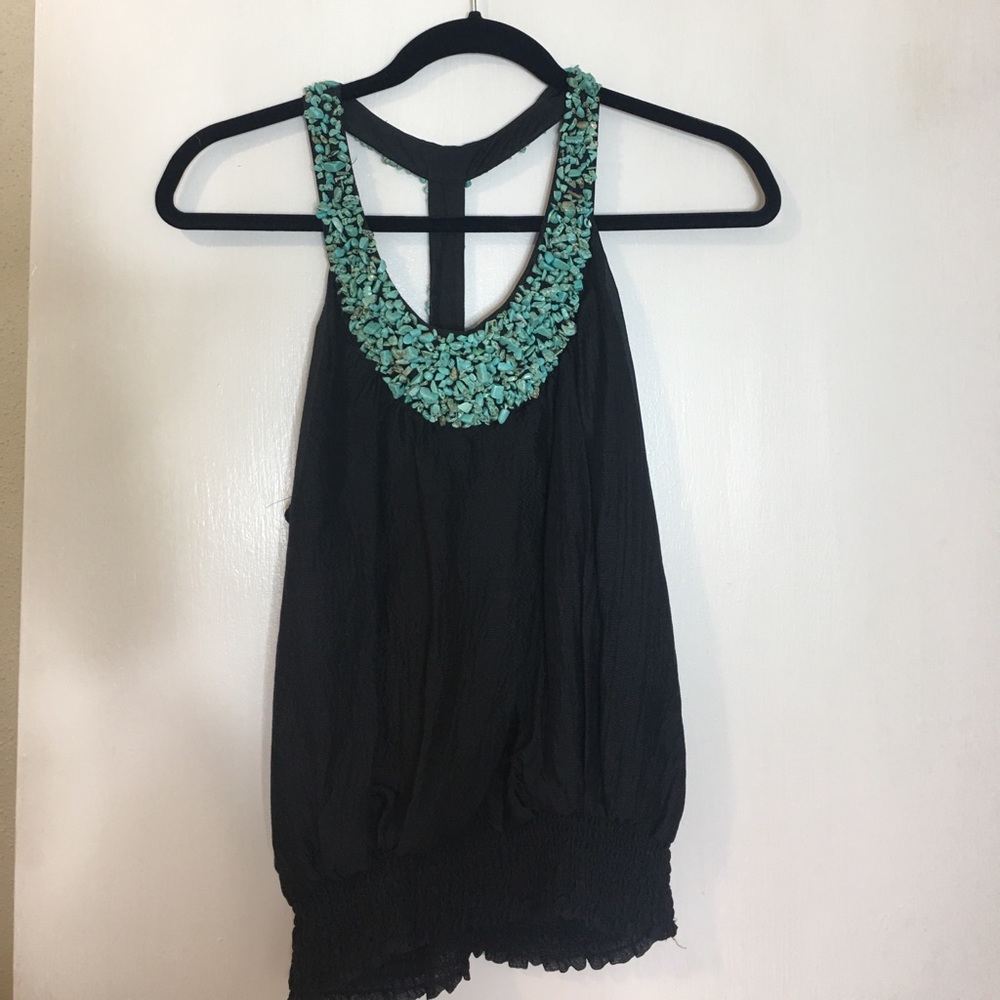 Black tank with turquoise headed details.