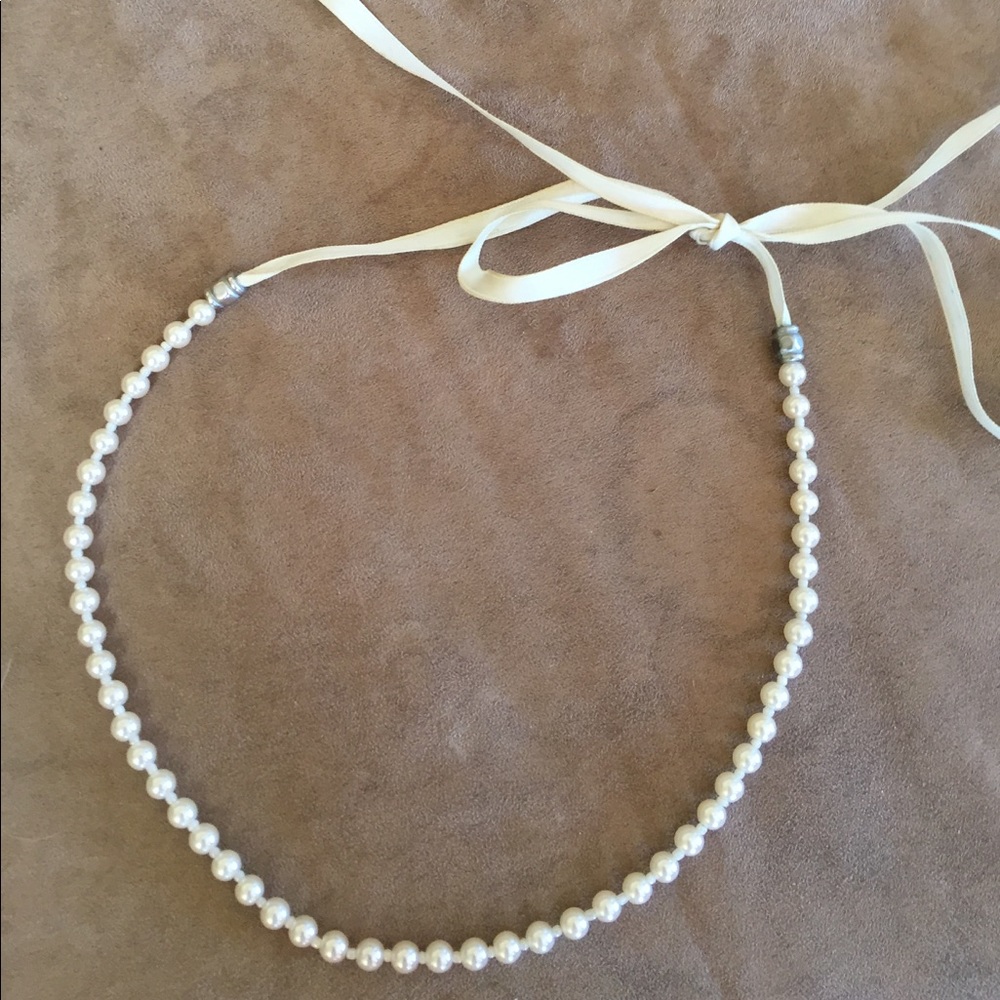Faux pearl necklace with cream satin ribbon tie.