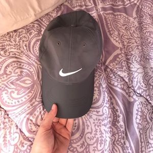 Grey, dry-fit Nike hat with an adjustable strap