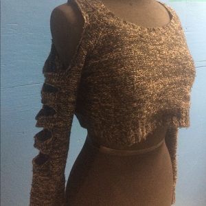 Trendy closet staple. Crop top w/ sexy arm cutouts