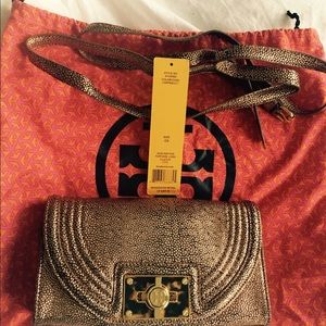 Tory Burch Clutch with strap for cross body.