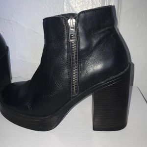 Black booties with a thick dark brown heel