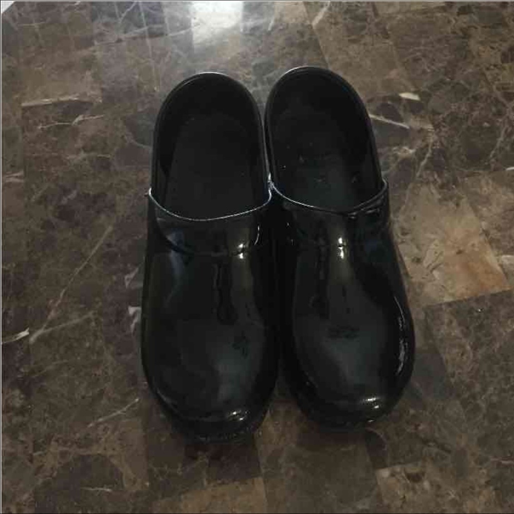 Dansko black shiny clogs . Some scuffing . Shown