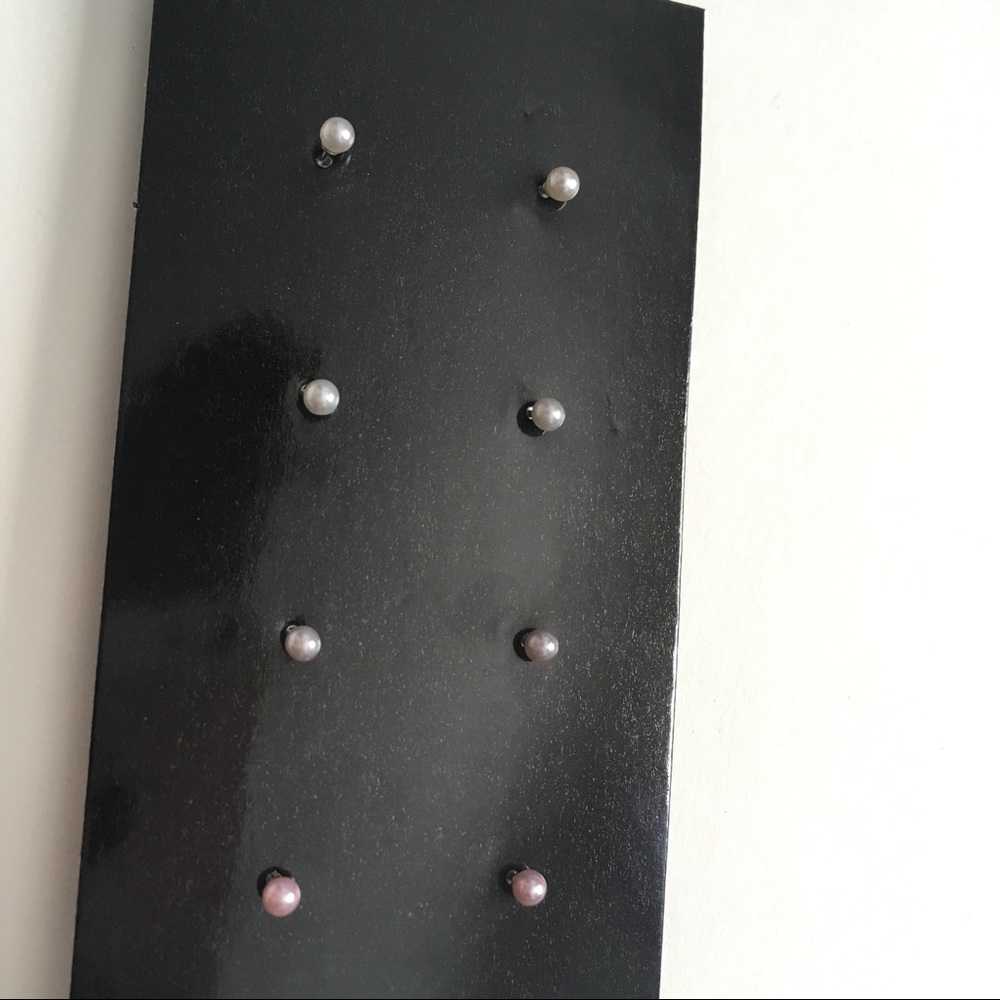 Four pairs of tiny pearl studs.