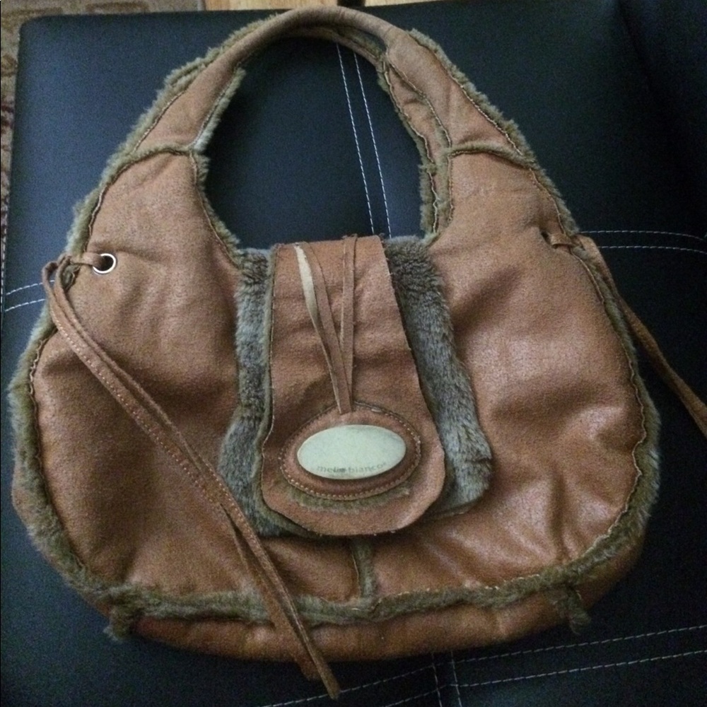 Saddle colored, sharp handbag