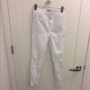 High waisted white jeans with holes in knees