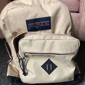 Tan and black Jansport City Traveller Backpack