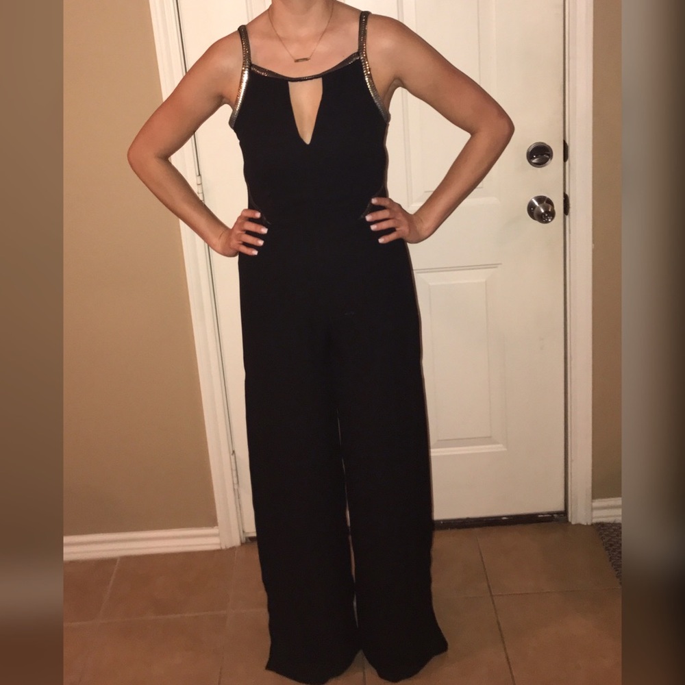 Black jumpsuit with gold metal trim
