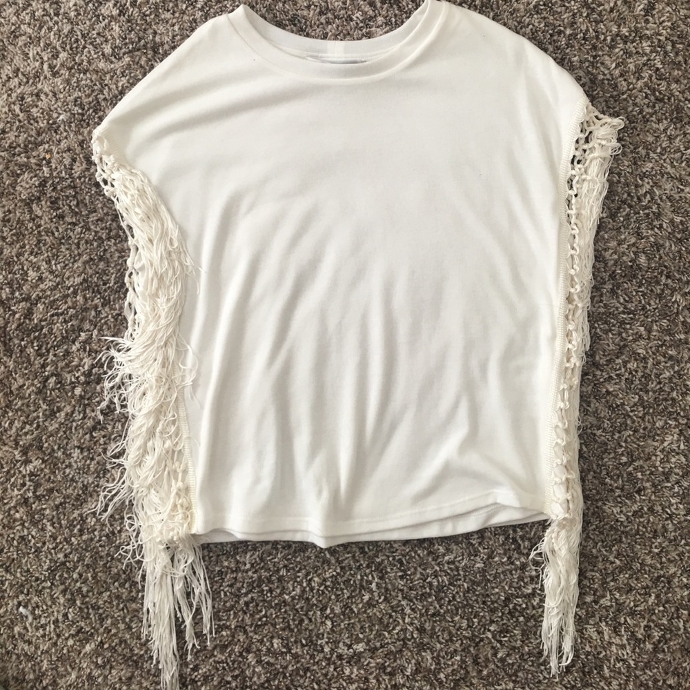 White top with fringe on the side