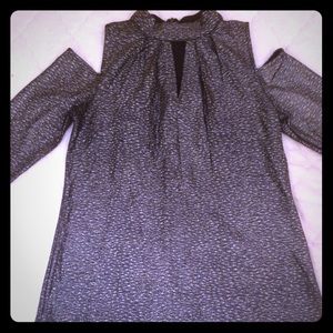 Long sleeved metallic shirt. Zipper in the back.