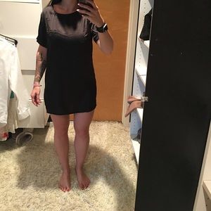 Classy shiny black t-shirt dress with front pocket