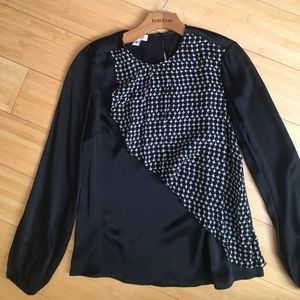 Black/white silk, bloose, sits around hip