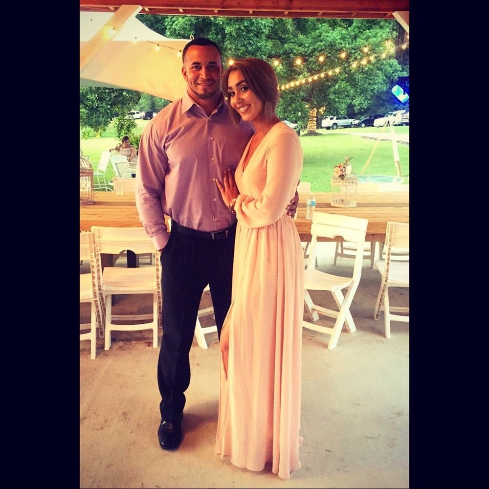 Blush evening gown, high slit.