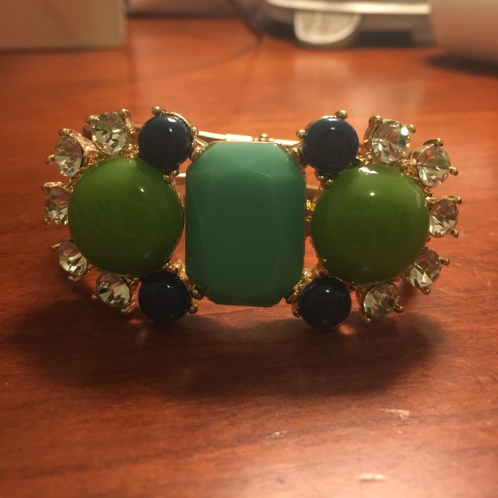 Gold clasp-front bejeweled bangle