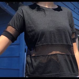 Black hip hop shirt. Mesh band in stomach and arms