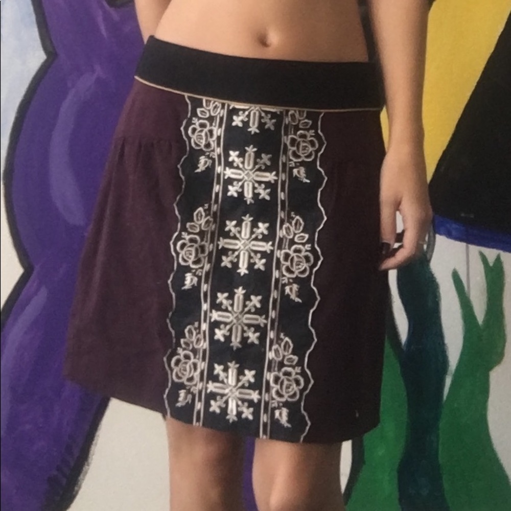 Maroon Anthropologie skirt with front decoration.