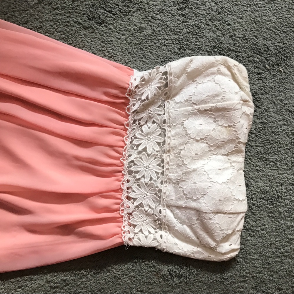 Peach and white strapless dress.