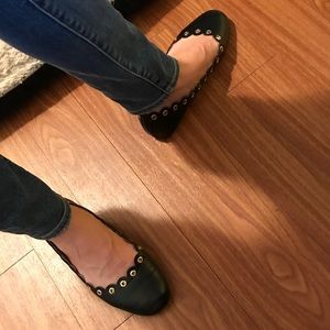 Black ballet flats with gold grommets